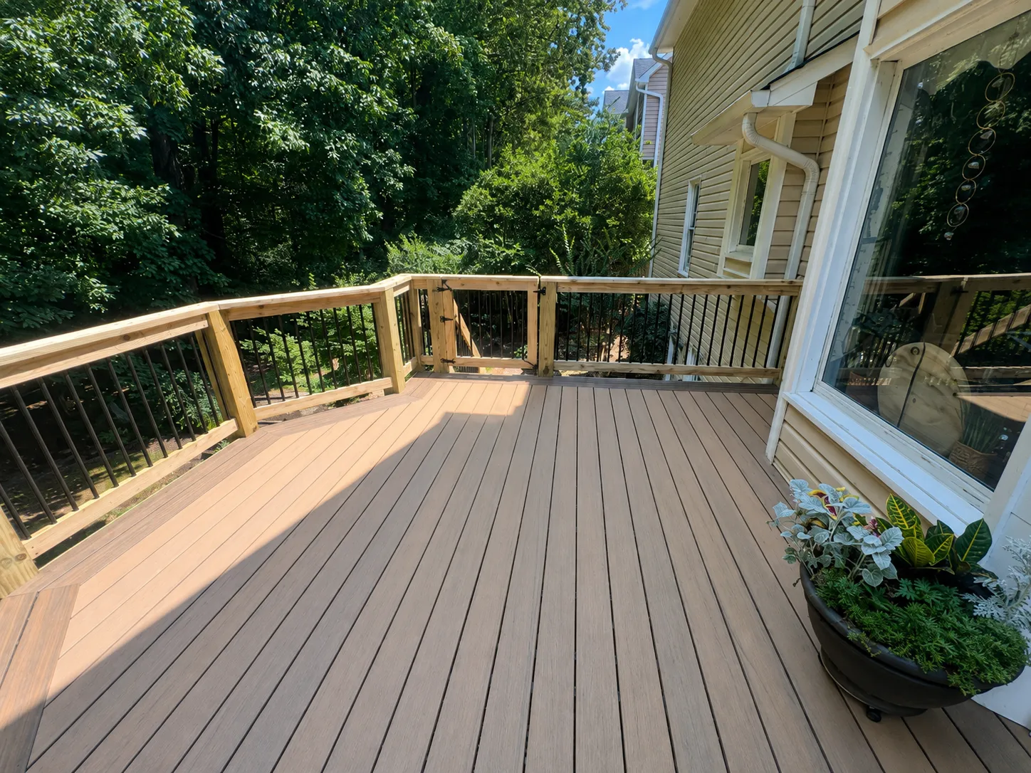 Wood deck builders in Fort Wayne constructing a custom cedar and pressure-treated wood deck
